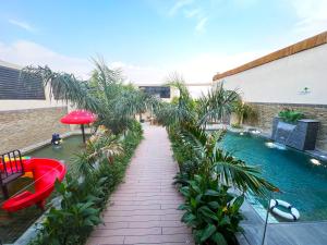 a balcony with a swimming pool and palm trees at Villa Bali Jeddah in Jeddah