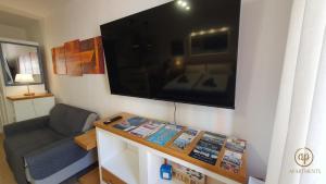 a living room with a large flat screen tv on a wall at Studio EMA - Tartini Square in Piran