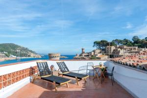 a patio with chairs and a table on a balcony at Hostal Boutique Es Menut in Tossa de Mar