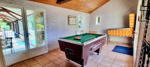 a room with a pool table in a room at O Gîte Bleu 