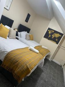 a bedroom with two beds in a attic at St James House - Sleeps 8! in Leeds