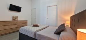 a bedroom with a bed with a dresser and a tv at DS Precioso LOFT a estrenar in Córdoba