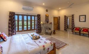 a bedroom with a large bed and a fireplace at Castle Oodeypore A Boutique stay Udaipur in Udaipur