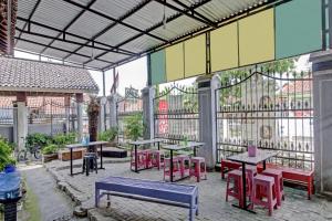 a patio with tables and chairs in a building at OYO 90543 An-nur Guest House Syariah in Kuningan