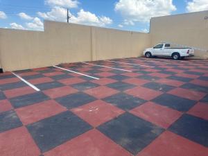 a car parked in a parking lot with a checkered floor at Sweet Nice Guest House in Ga-Rankuwa