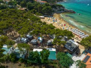 an aerial view of a beach with people and tents at Camping Europa in Capoliveri