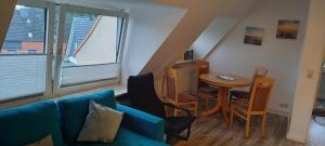 a living room with a blue couch and a table at Ferienwohnung Resi in Lübeck