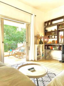 a living room with a door open to a patio at כפר בלב העיר ליד הים המיקום המושלם בתל אביב in Tel Aviv