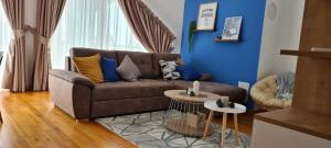 a living room with a brown couch and a blue wall at Cozy Corner Zlatibor in Zlatibor