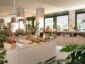 a kitchen with fruits and vegetables on a counter at Mercure Milano Agrate Brianza in Agrate Brianza