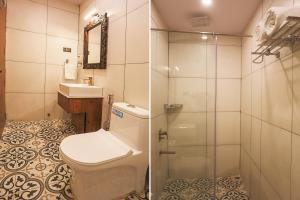 a bathroom with a toilet and a sink and a shower at Ekta Houseboat Statue Of Unity Kevadia in Vadodara