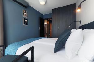 sypialnia z dużym białym łóżkiem z niebieskimi ścianami w obiekcie Apartamenty Jozefina w mieście Białystok