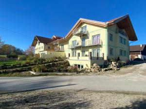 a large house on the side of a street at HotelPension Weberhof in Ebersberg