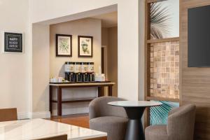 a waiting room with two chairs and a table at Hampton Inn Pembroke Pines in Pembroke Pines