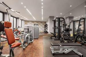 a gym with several treadmills and exercise equipment at Vienna House by Wyndham Andel's Berlin in Berlin
