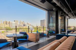 a room with a view of a city skyline at The Godfrey Detroit, Curio Collection By Hilton in Detroit