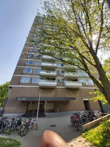 a tall building with bikes parked in front of it at Sky Home Room 1 in Amsterdam