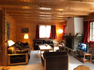 a living room with leather furniture and a fireplace at Chalet Hockenhorst, 1-10 personen -Familiechalet in fijn skigebied in Kippel