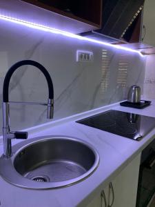 a kitchen sink with a faucet on a counter at Harmony cozy home in Podgorica