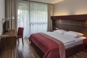 Ліжко або ліжка в номері Asia Hotel & Spa Leoben