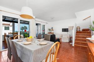 a dining room and living room with a table and chairs at Apartamento Arenal Jardin in Arenal d'en Castell