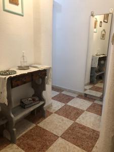 a bathroom with a table and a mirror at Vallaindiano in Córdoba