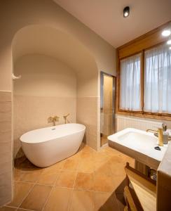 a large bathroom with a tub and a sink and a tub at Can Passarells in San Vicente de Torelló