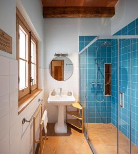 a bathroom with a sink and a shower at Can Passarells in San Vicente de Torelló