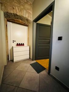 a hallway with a door and a dresser in a room at Nature Cottage King Size Room without shower 