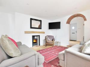 a living room with two couches and a fireplace at 3 Bed in Folkestone 75607 in Sandgate