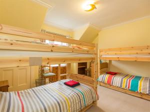 two bunk beds in a room with yellow walls at 5 Bed in Brodick CA016 in Brodick