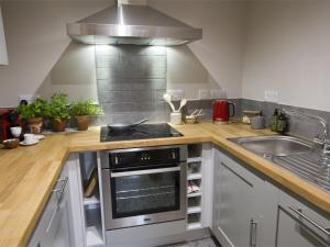 a kitchen with a stove and a sink at 1 Bed in Goathland G0157 in Goathland