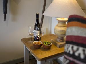a table with a bottle of wine and a bowl of fruit at 1 Bed in Goathland G0157 in Goathland