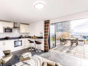 a kitchen and living room with a table and chairs at 1 Bed in Combe Martin 77349 in Loxhore