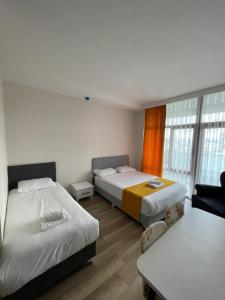 a hotel room with two beds and a table at COLORFUL LİFE ÇAYYOLU in Ankara