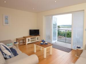 a living room with a couch and a large window at 4 bed in Appledore 76483 in Appledore