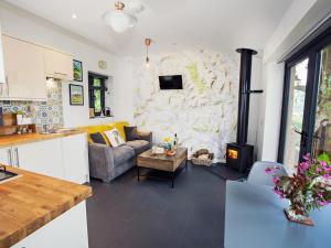a kitchen and living room with a stone wall at 1 bed property in Gilwern Brecon Beacons 75206 in Gilwern