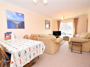 a living room with a bed and a couch at 2 Bed in Mundesley 75398 in Mundesley