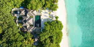 an aerial view of a beach and the ocean at JA Manafaru Maldives in Dhidhdhoo