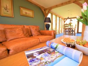a living room with a couch and a table with a magazine at 1 Bed in Croyde 75270 in Marwood