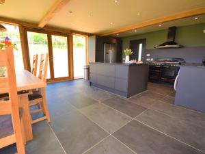 a large kitchen with a table and a stove at 1 Bed in Croyde 75270 in Marwood