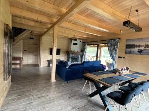 a living room with a blue couch and a table at Dom Pod Lasem in Rydzewo