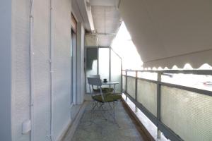 uma varanda com uma mesa e cadeiras em You & Me Cozy Apartments em Atenas