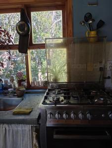 a kitchen with a stove with a fish tank at Casita en el bosque in San Carlos de Bariloche
