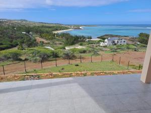 a view of a house and the ocean at La Residence Emmaüs in Rodrigues Island