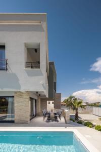 a villa with a swimming pool and a house at Villa Nadja ZadarVillas in Bibinje