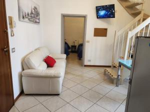 a living room with a white couch with a red pillow at Il BorgoMct a Montecatini Terme in Montecatini Terme
