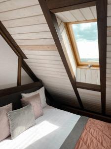 a bed in a room with a window at Villa Blanc in Bukovel
