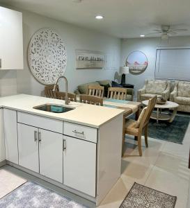 a kitchen and living room with a table and a couch at Casa Flamenco in West Palm Beach