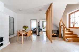 a living room with a table and a fireplace at Kőkapocs in Mindszentkálla